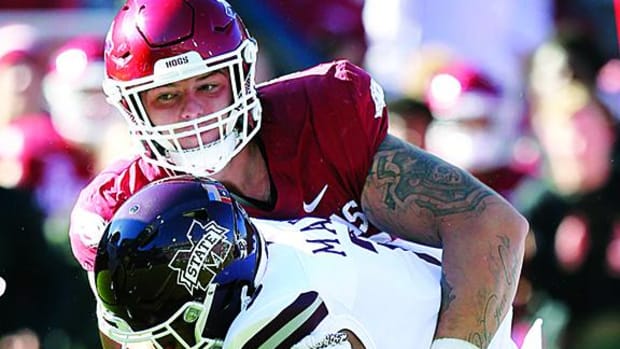 Arkansas Razorbacks defensive lineman John Ridgeway tackles Mississippi State Bulldogs running back Jo'quavious Marks during the first quarter at Donald W. Reynolds Razorback Stadium.
